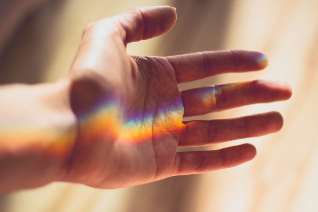 Lightworker hand with rainbow prism reflection