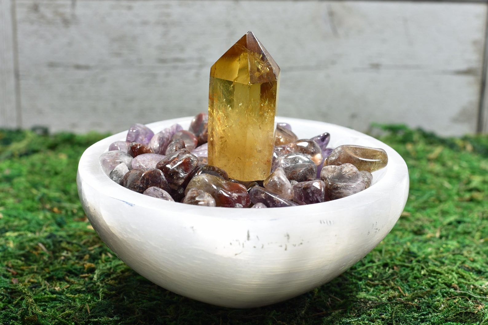 Selenite bowl filled with crystals and topped with a citrine tower