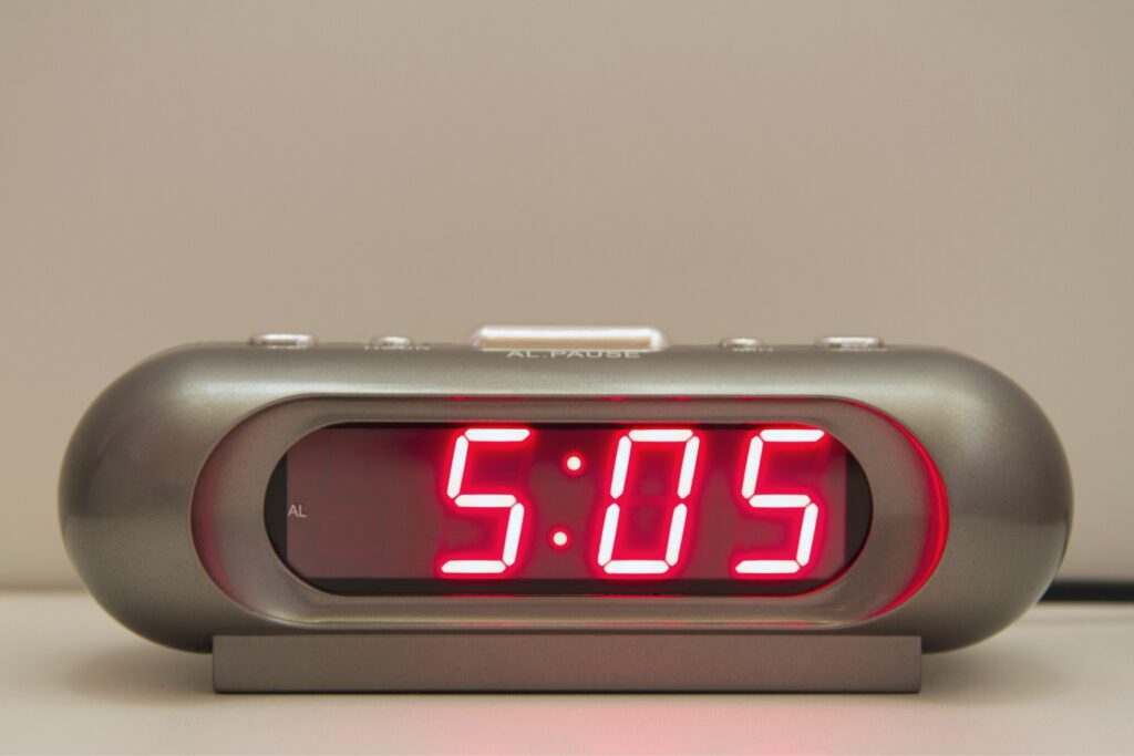 A digital clock reading 5:05