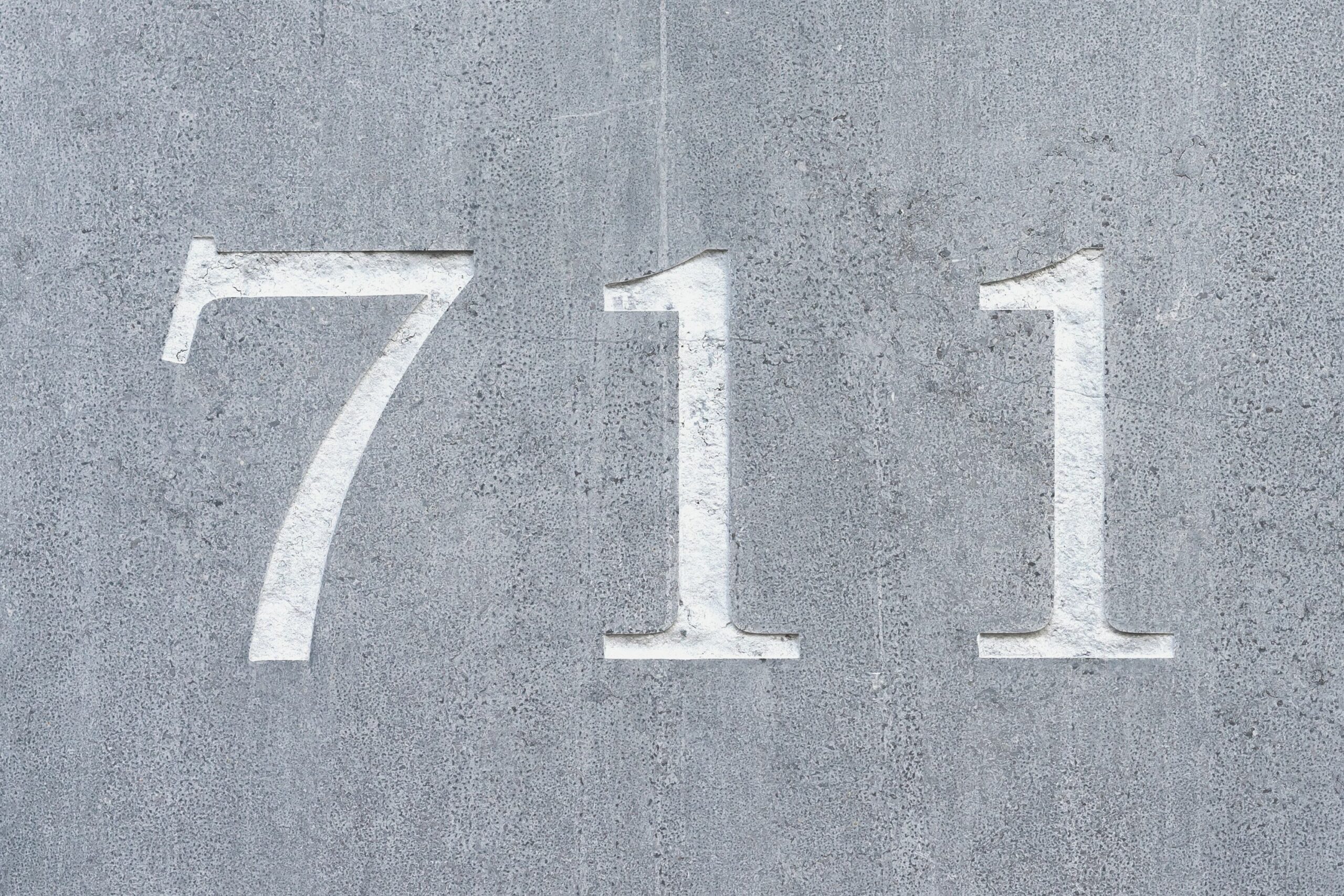 The numbers 711 etched in concrete