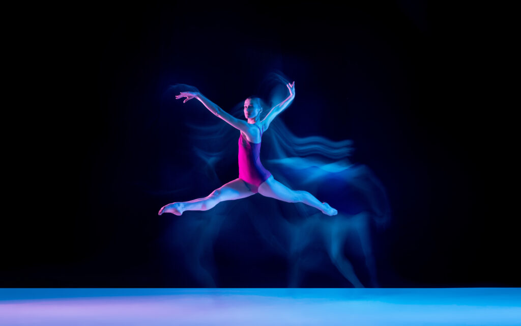 Ballet dancer onstage with blue aura emanating from body